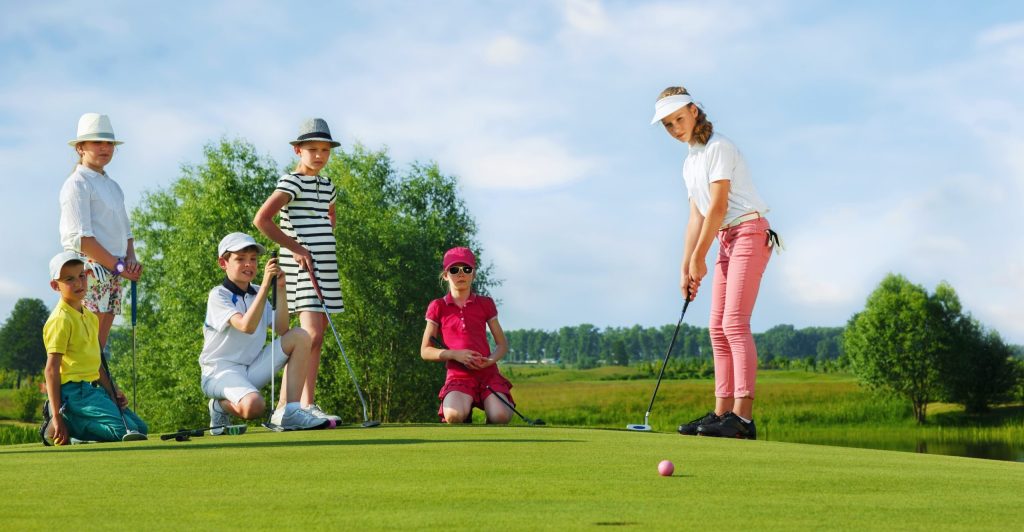 Summer Junior Golf Camps - Kids Playing golf scaled e1713265474399